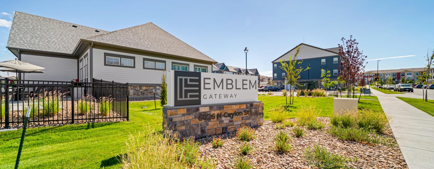 The essence of exceptional living a sign in a grassy area