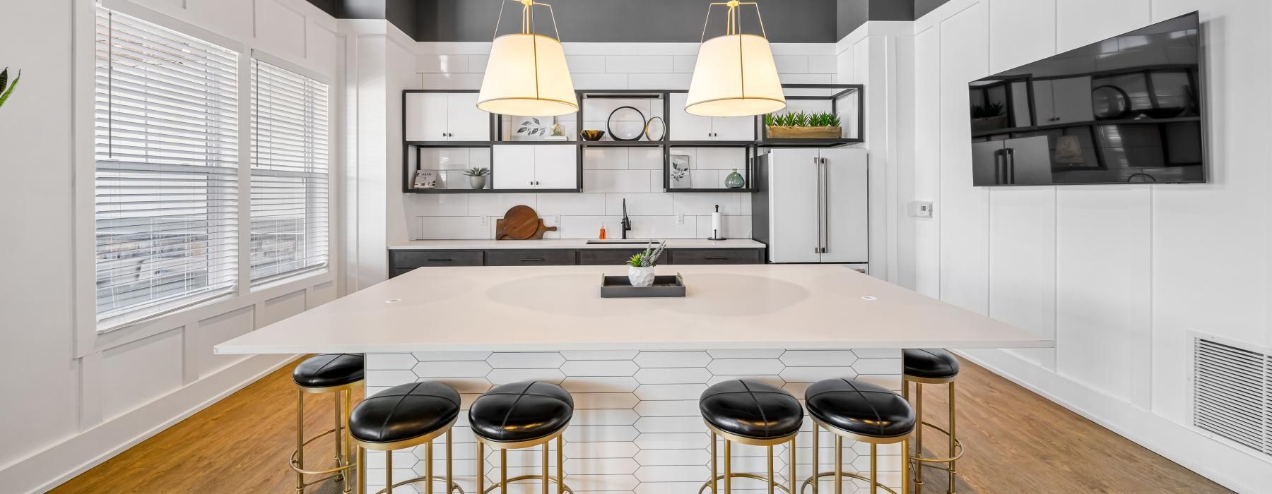 a kitchen with stools and a bar stool